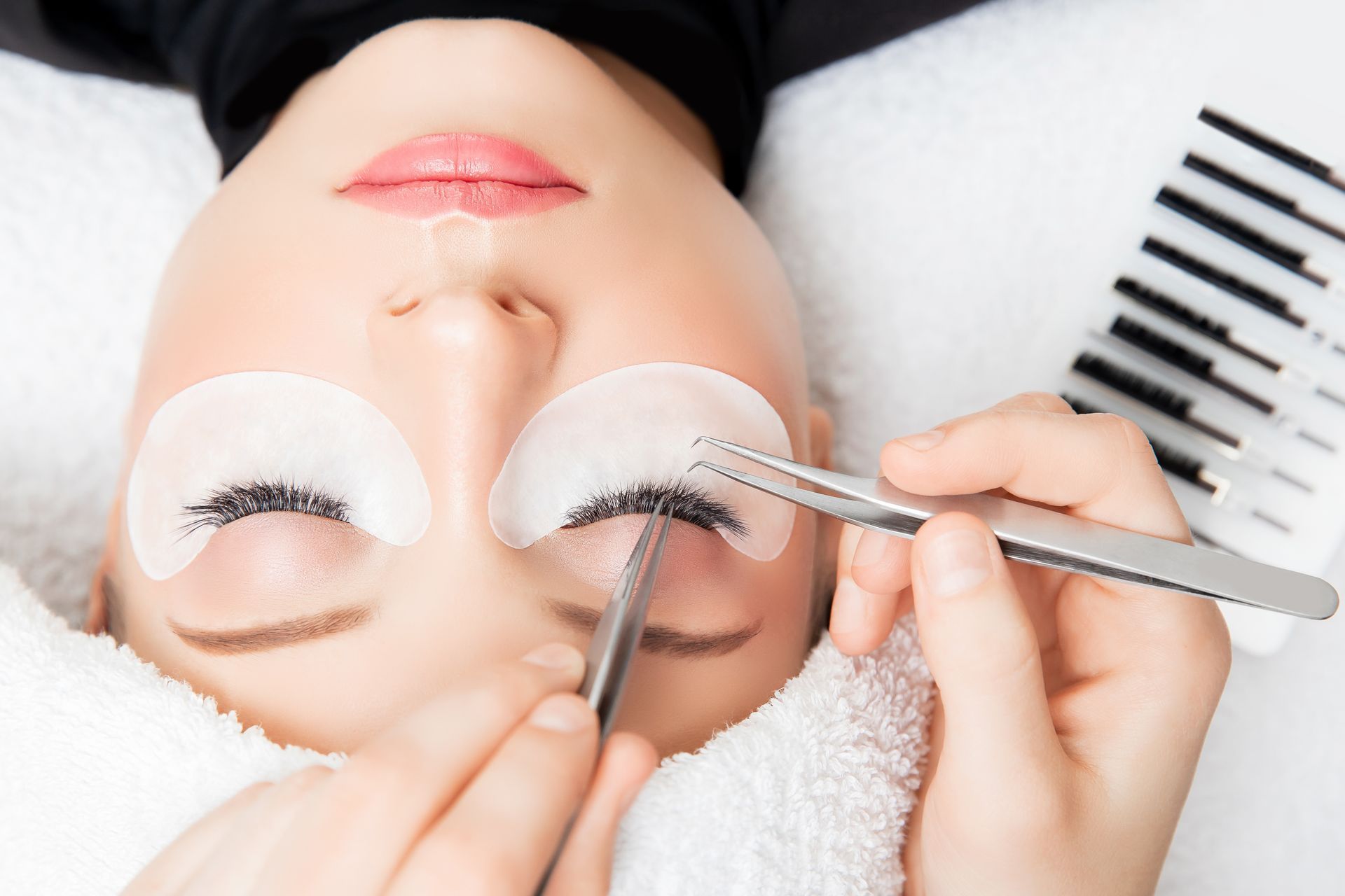 A woman is getting her eyelashes done at a beauty salon.