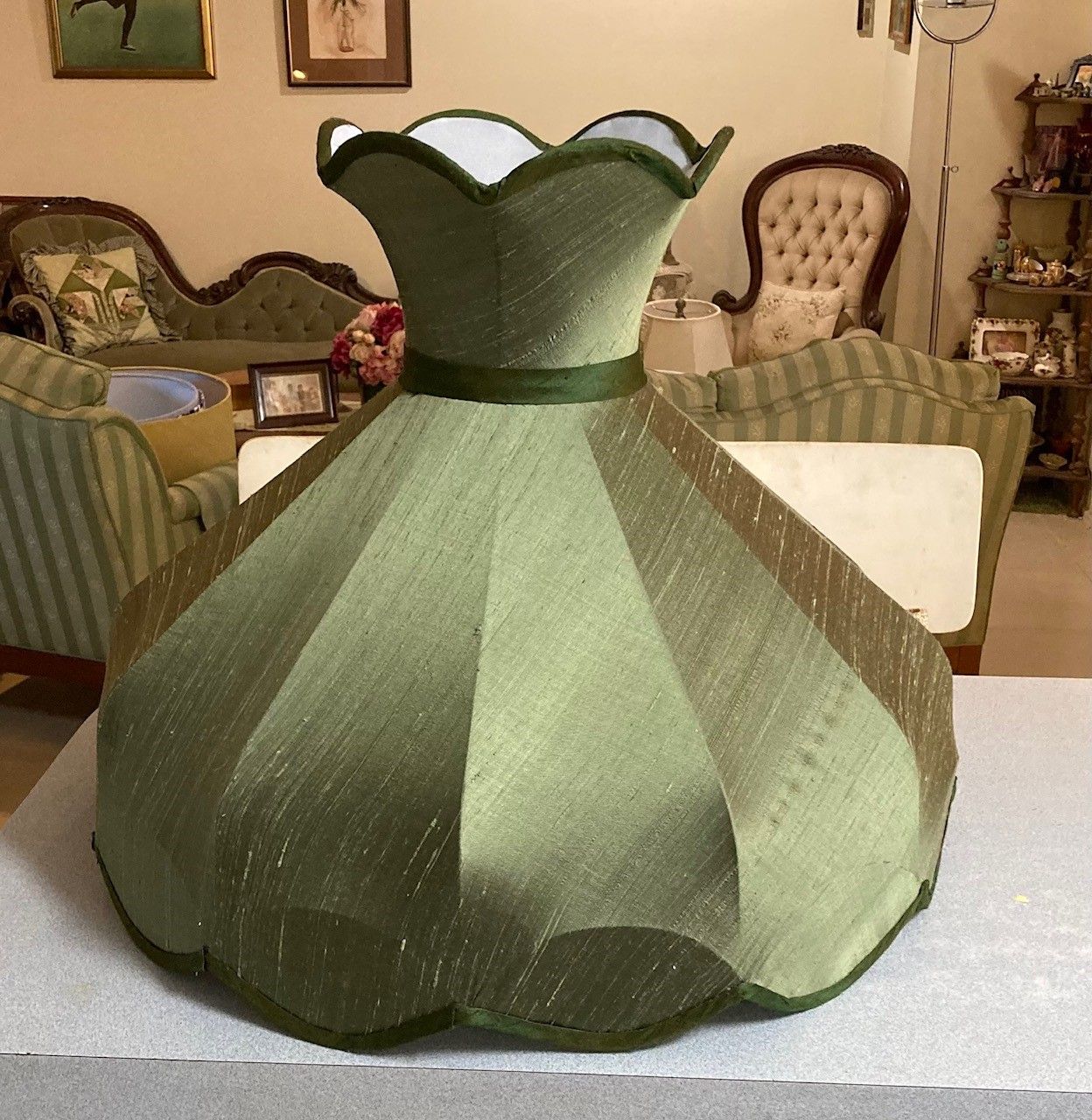 A lamp with a plaid shade is sitting on a table.