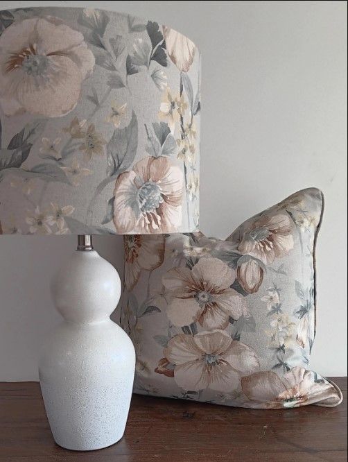 A lamp and a pillow with flowers on them