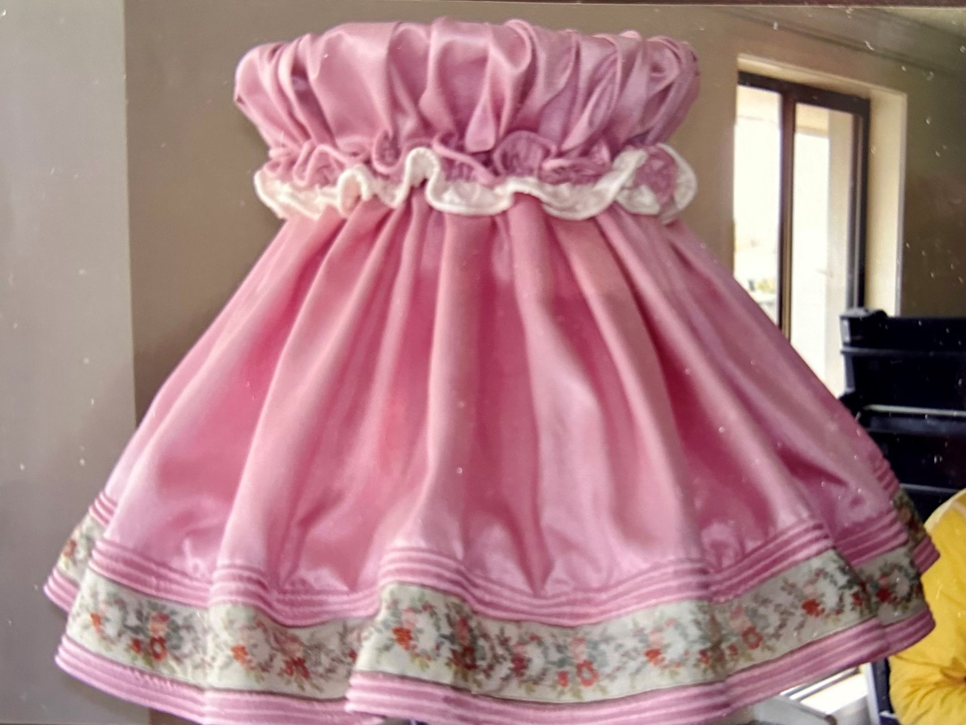 A lamp with a blue shade is sitting on a wooden table.