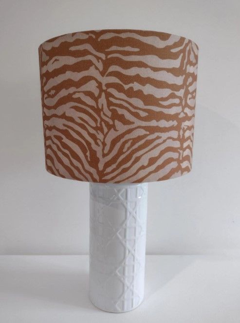 A lamp with a zebra print shade on it