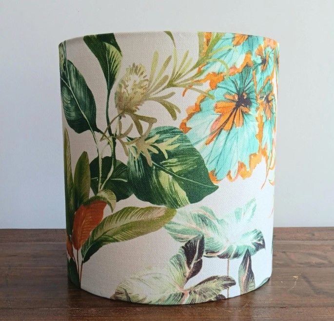 A lampshade with flowers and leaves on it