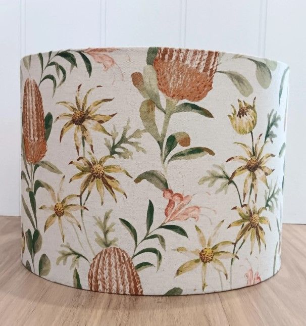 A lampshade with flowers and leaves on it