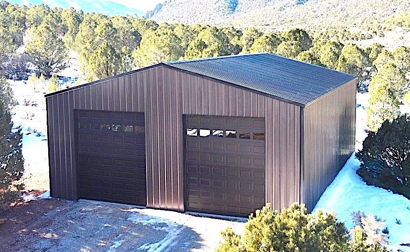 An aerial view of a large metal building with a porch.