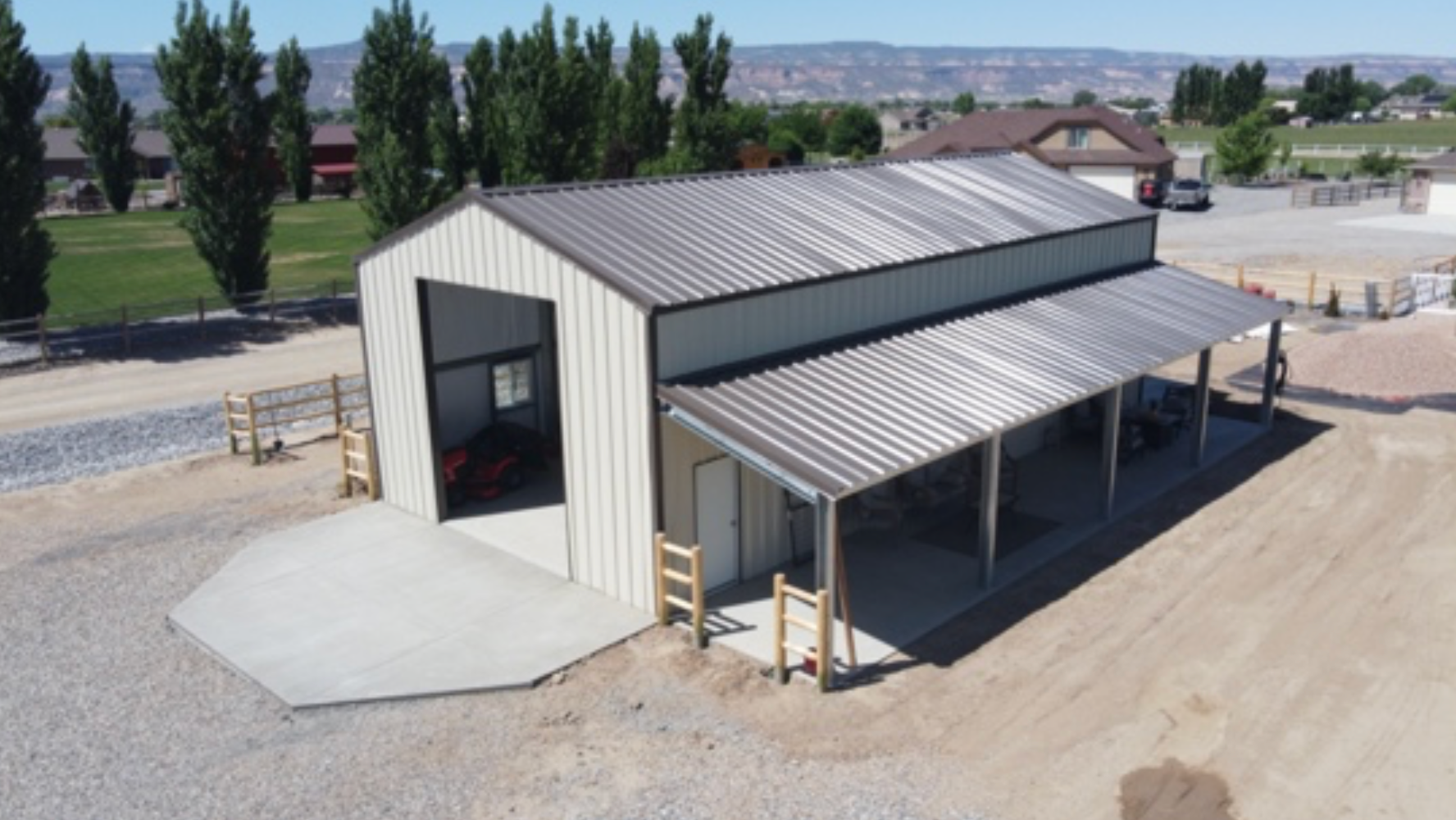 An aerial view of a large metal building with a porch.