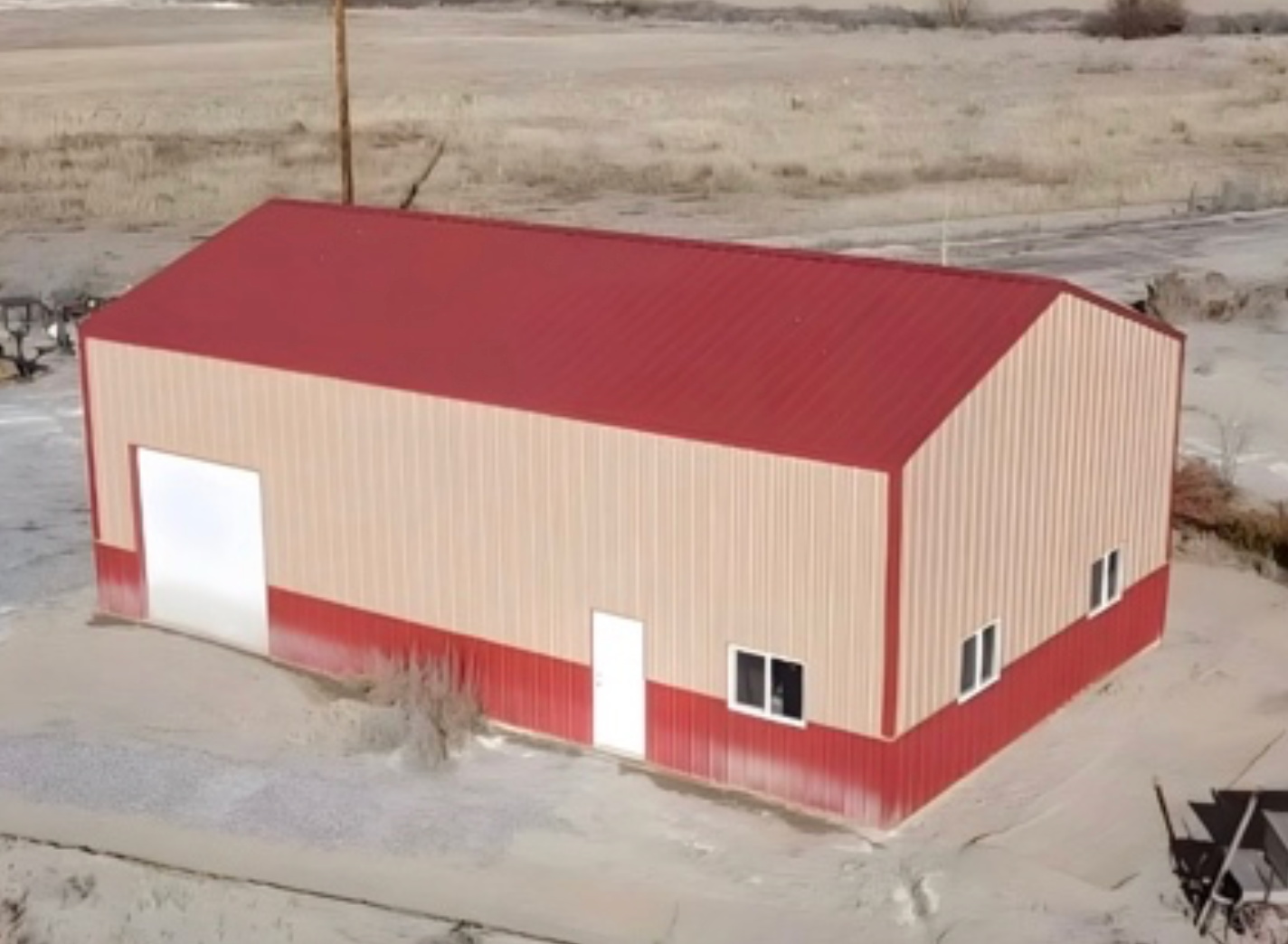 An aerial view of a building with a red roof