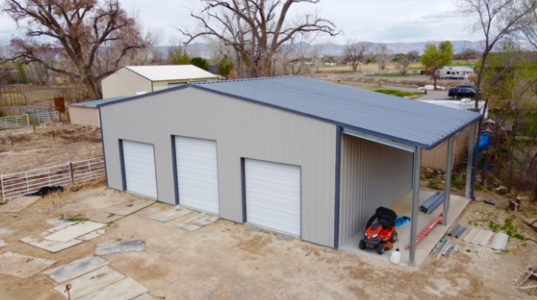 An aerial view of a garage with a atv parked inside of it.