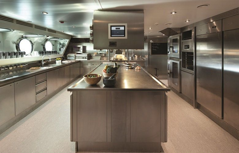 A man is fixing a television in a laundry room.