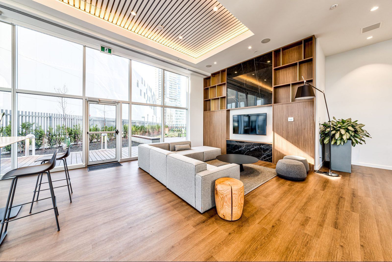 Mechanic fixing exercise equipment, wearing gloves, surrounded by tools, gym setting.