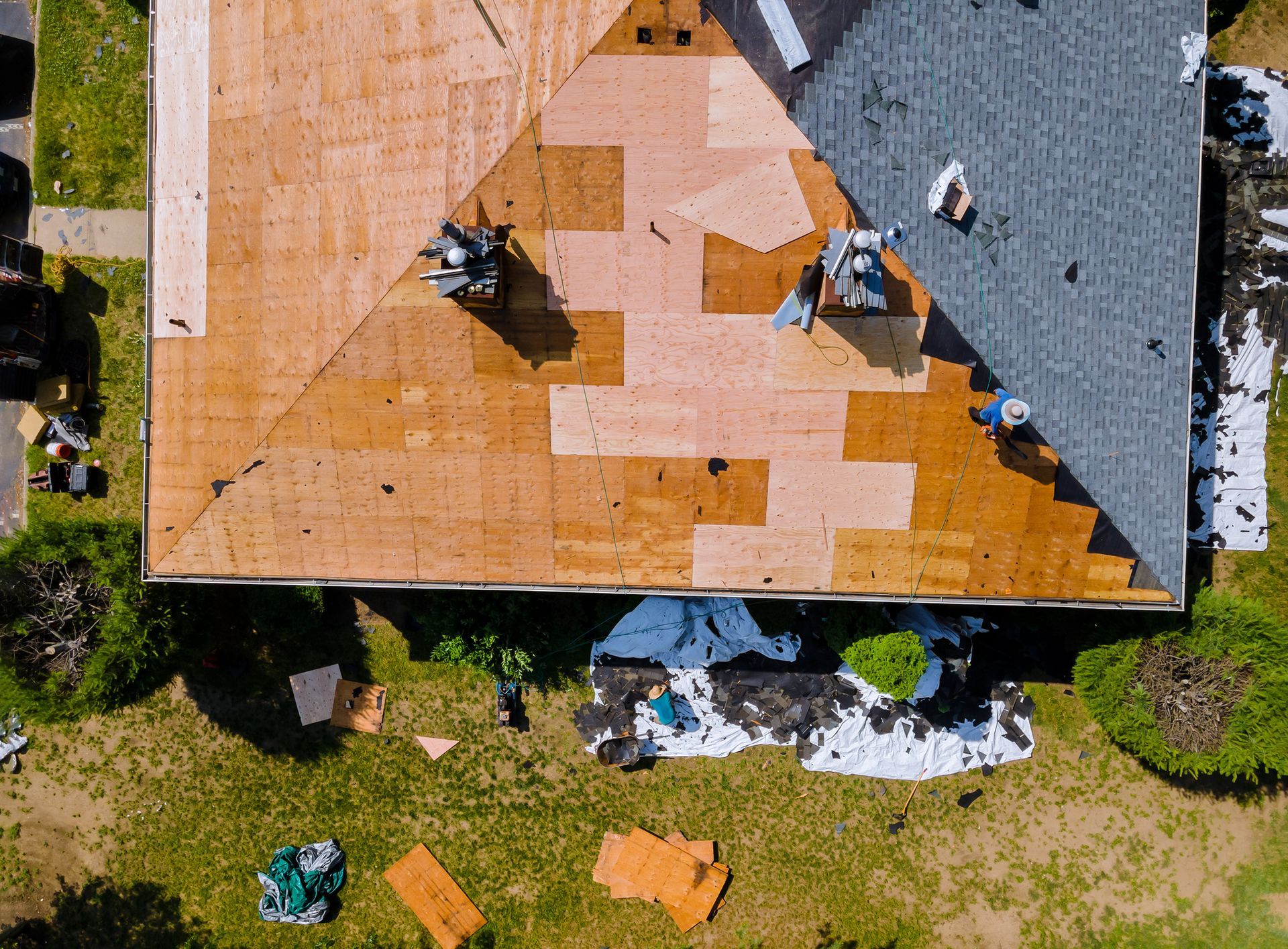 An aerial view of a roof being installed on a house.