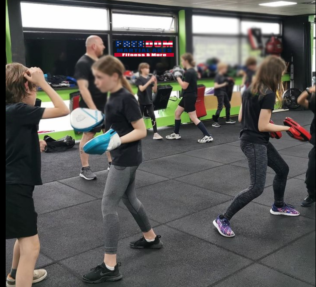 a group of people are practicing martial arts in a gym
