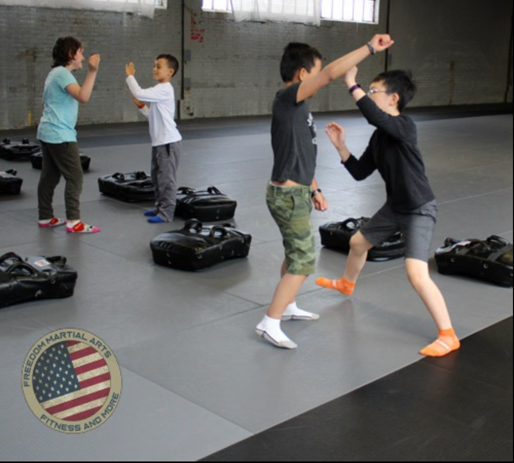 a group of kids are practicing martial arts in a gym