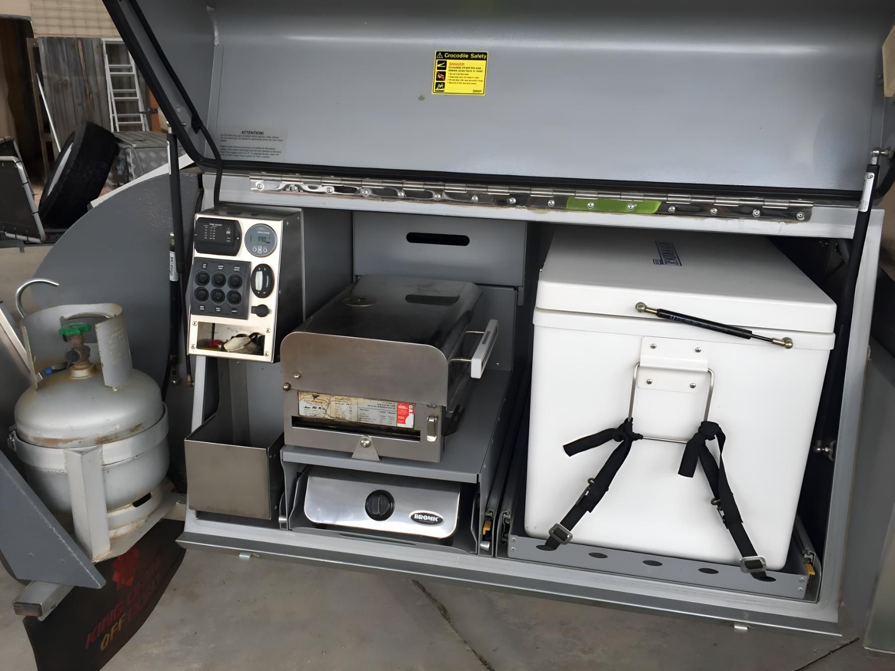 The Inside Of A Trailer With A Propane Tank And A Refrigerator — Coastal Gasfitting & Plumbing In Mount ST John, QLD