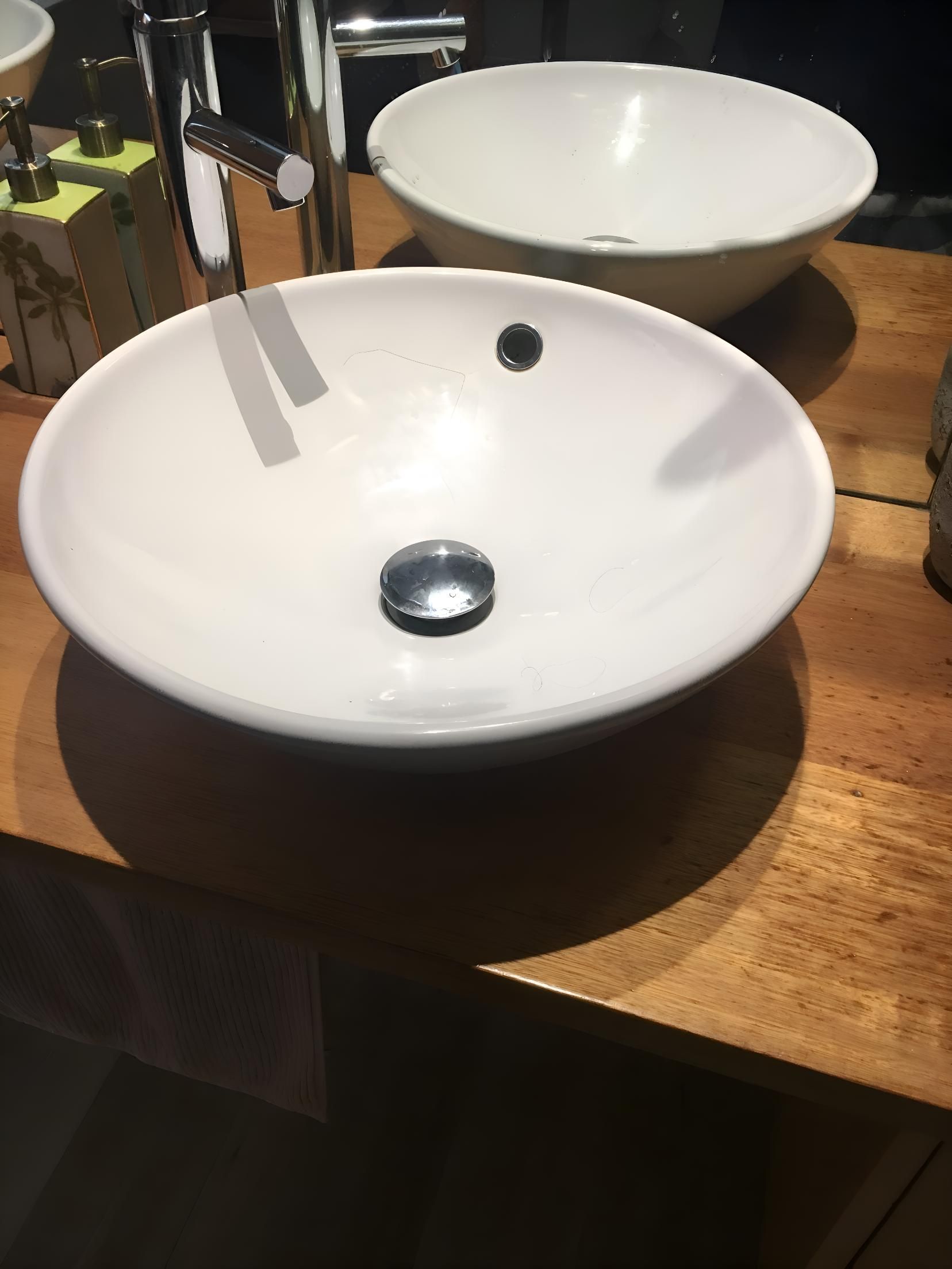 Two White Sinks Are On A Wooden Counter In A Bathroom — Coastal Gasfitting & Plumbing In Annandale, QLD