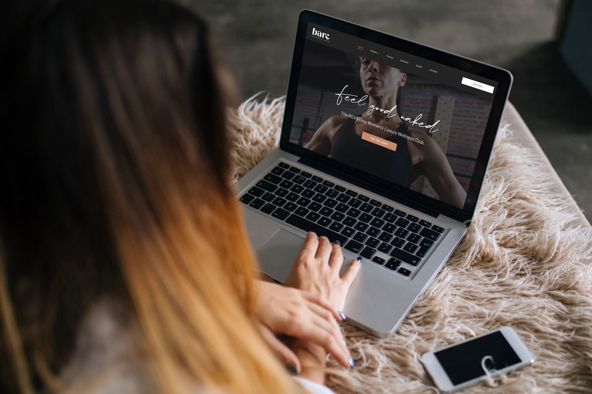 A laptop computer is sitting on a table with a woman on the screen.