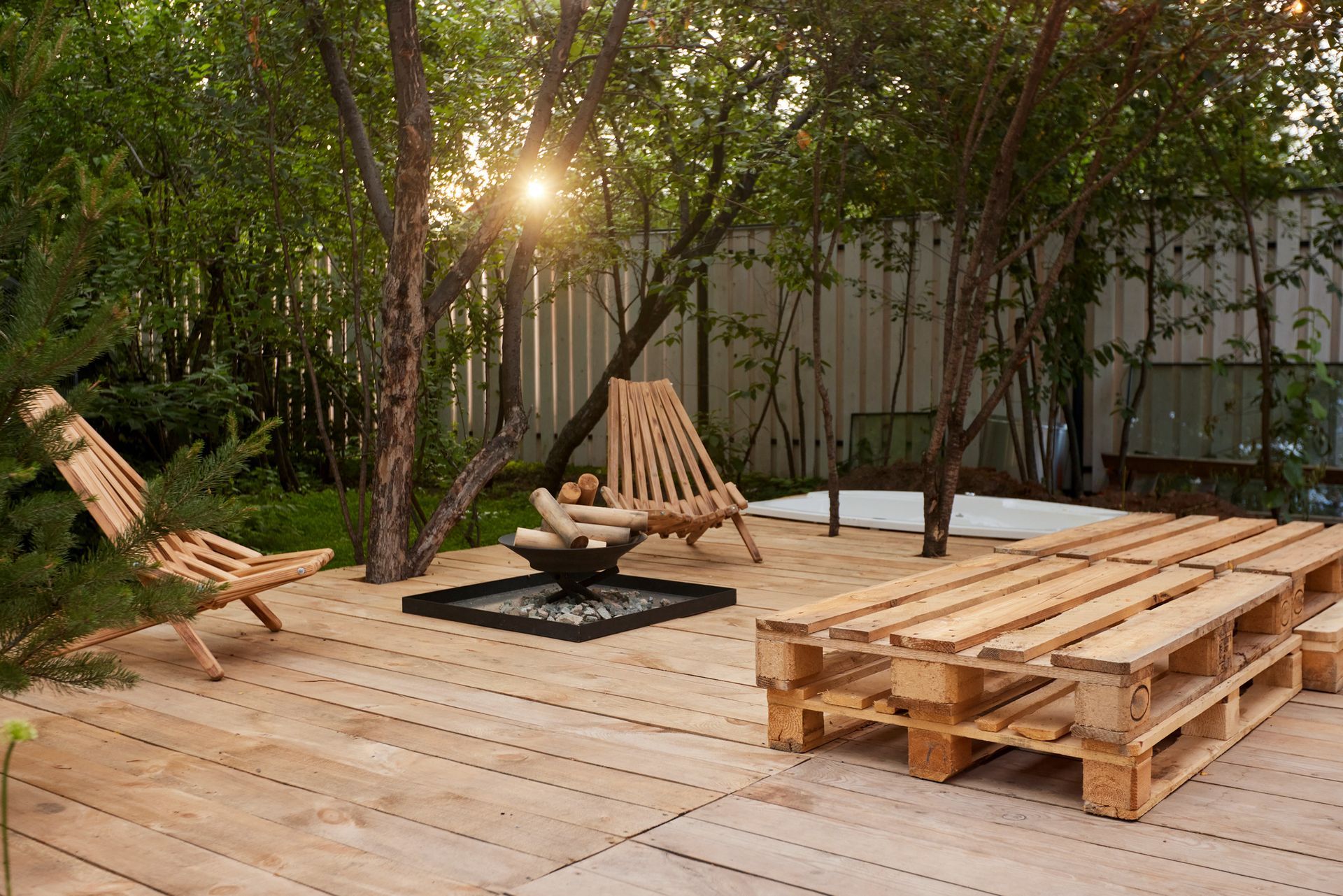 Cozy outdoor space with fireplace and chairs on wooden decking lumber, perfect for relaxing | Piedmo