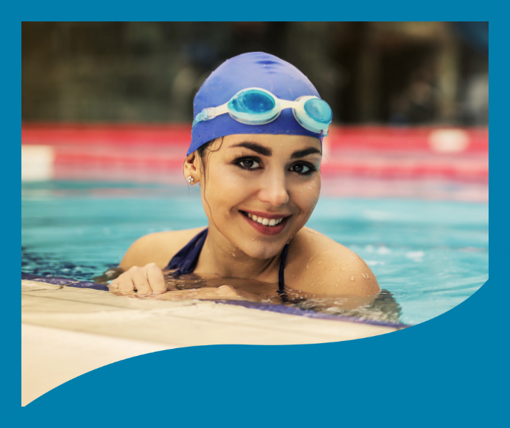A woman wearing a swim cap and goggles is swimming in a pool.