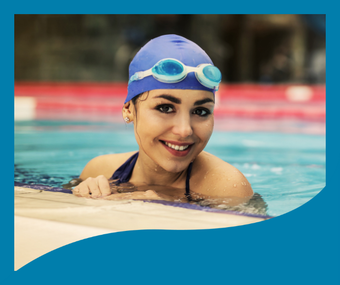 A woman wearing a swim cap and goggles is swimming in a pool.