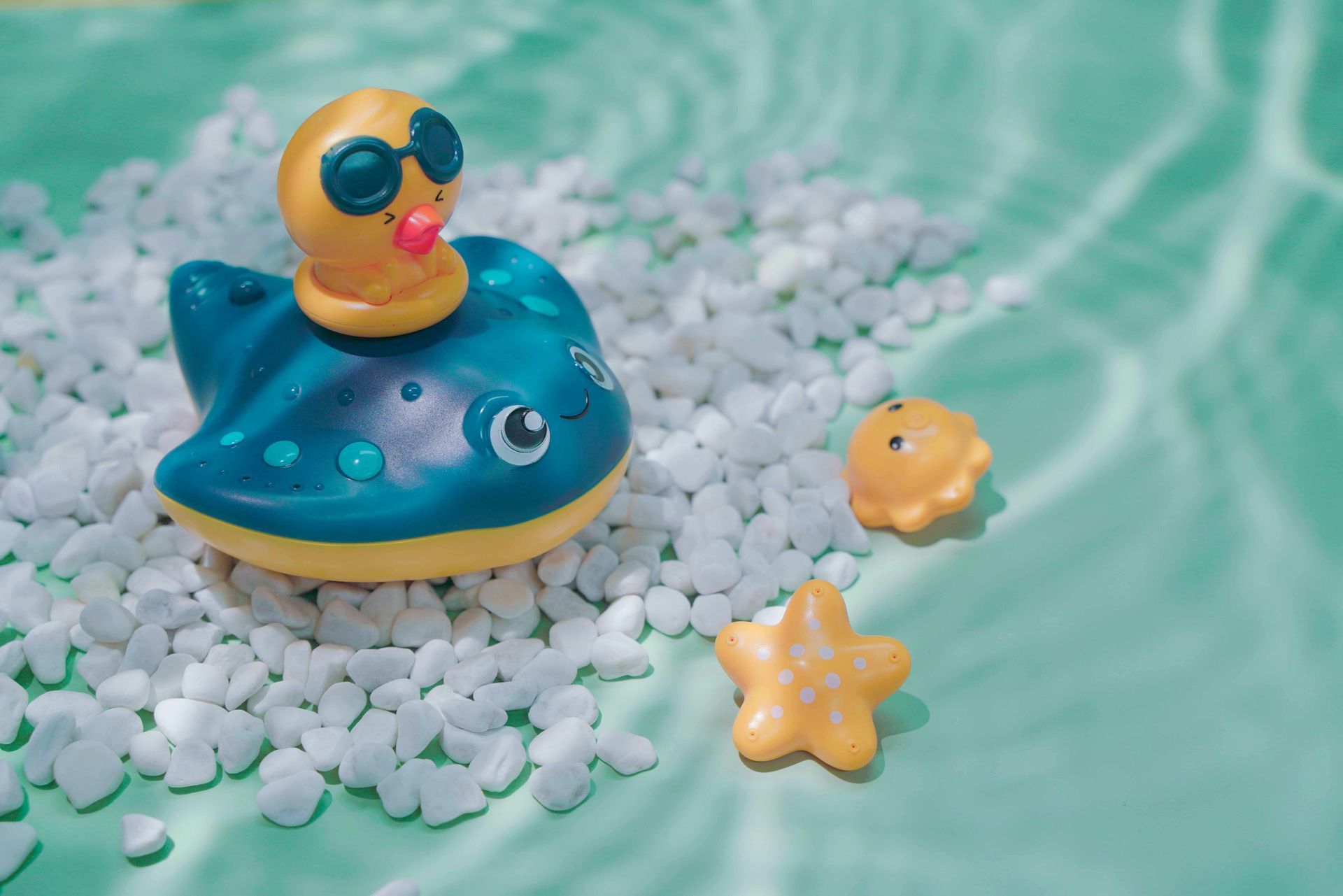A rubber duck wearing sunglasses is floating in a pool of water.