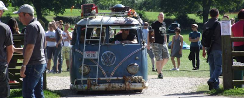 old blue split screen Volkswagen camper van at a festival