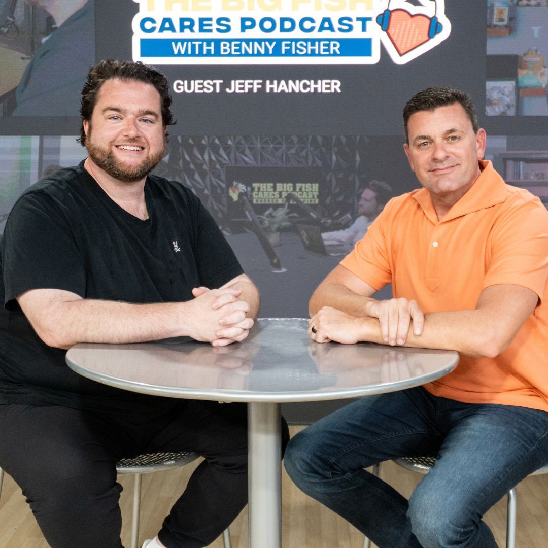 Two men sit at a table with benny fisher and guest jeff hancher