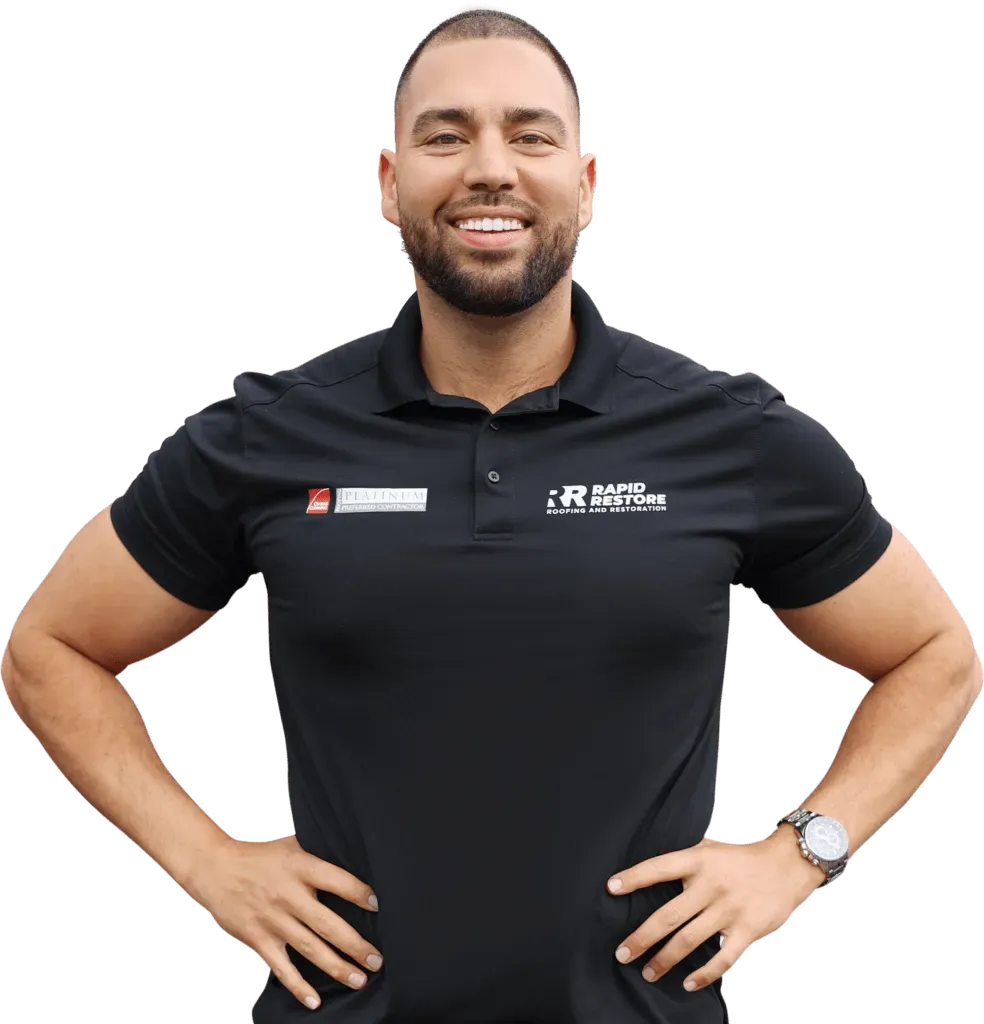 A man with a beard is wearing a black polo shirt and a watch.