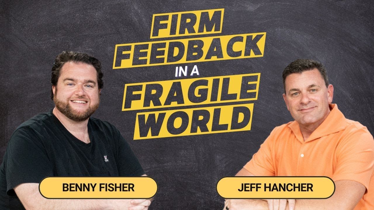 Two men are sitting next to each other in front of a sign that says firm feedback in a fragile world