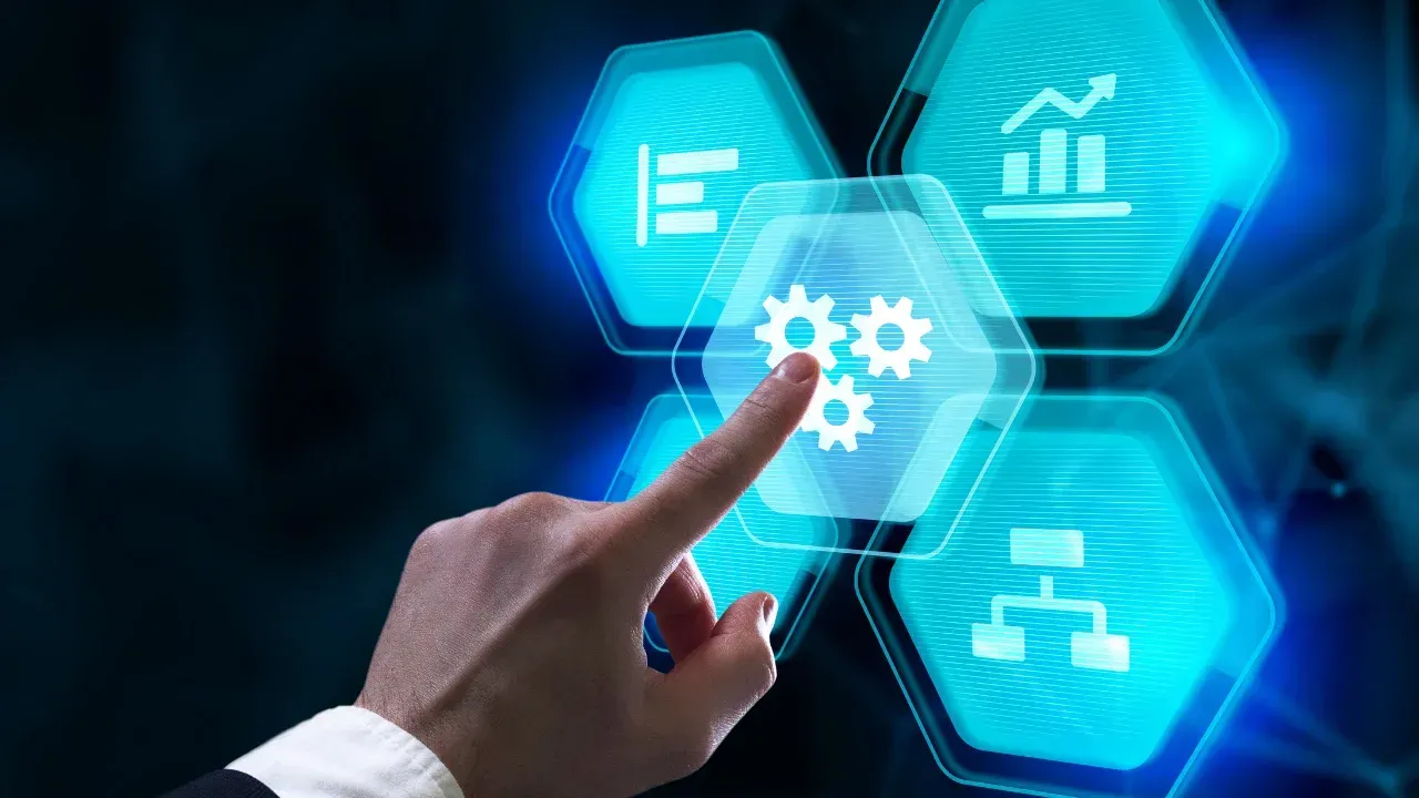 a hand pressing a touchpad button with gears on it, next to other icons