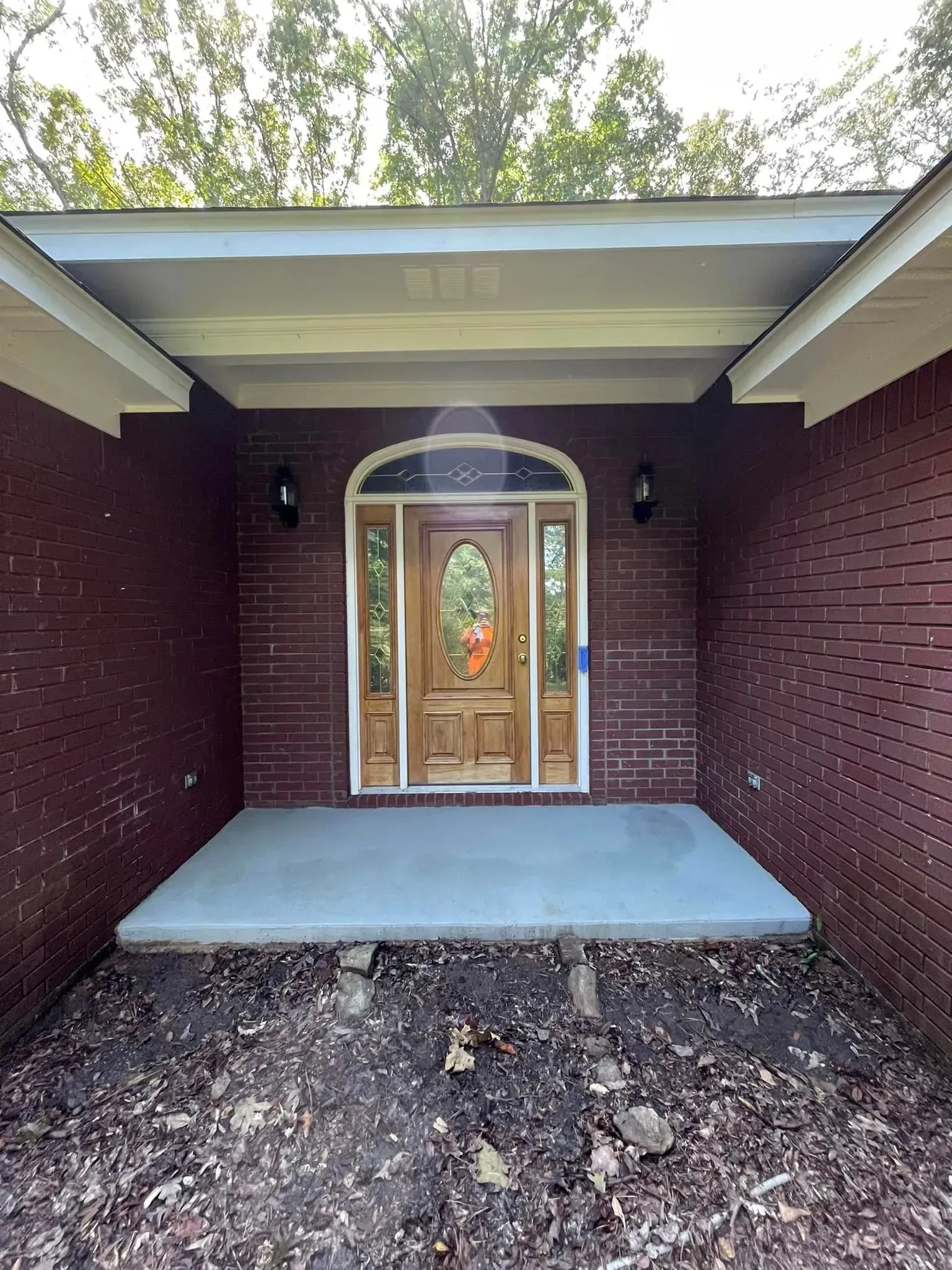 Brick facade with a covered porch and front door.