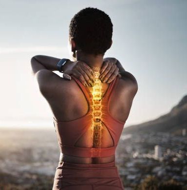 A woman is holding her neck in pain while a glowing spine is visible behind her.