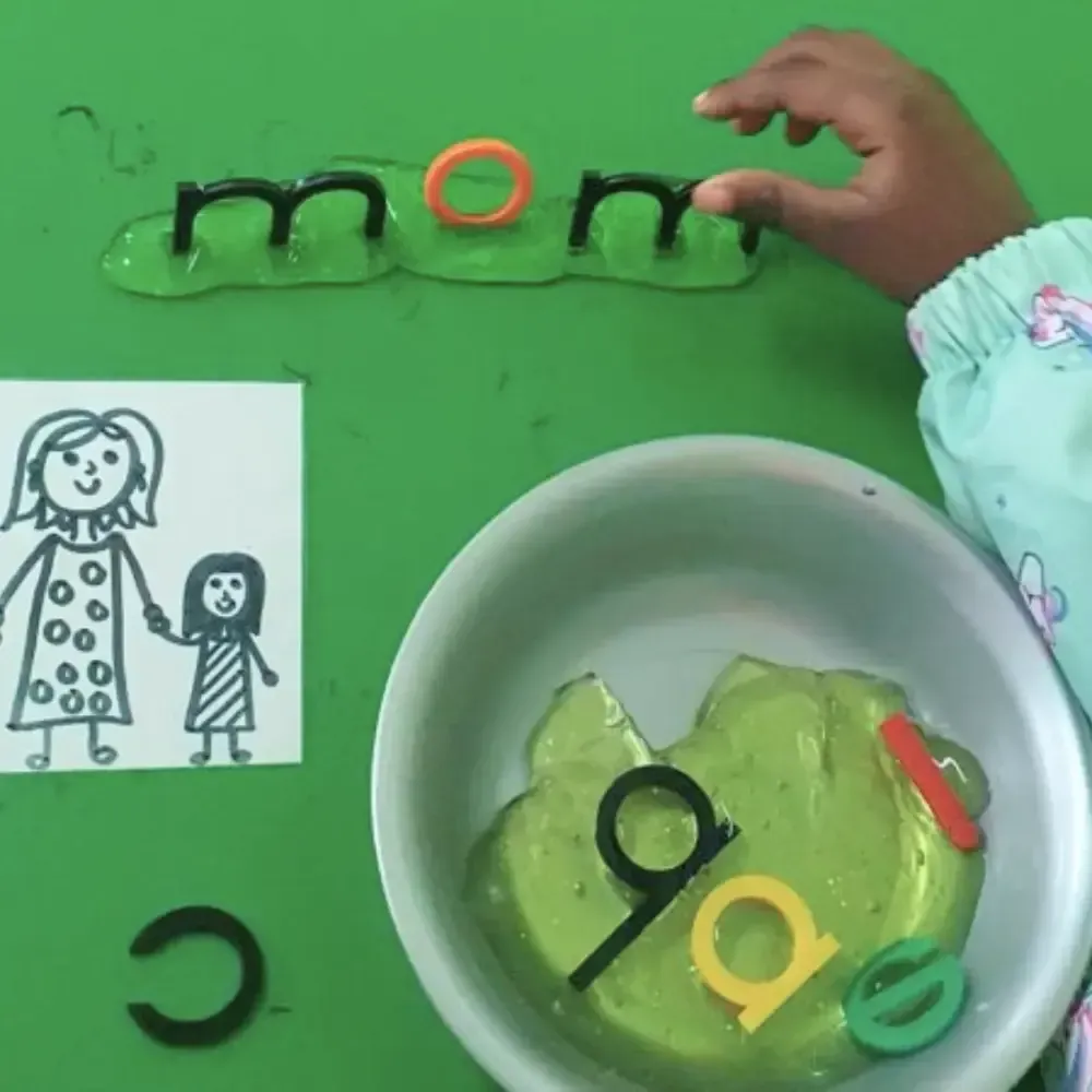 Child assembling the word 