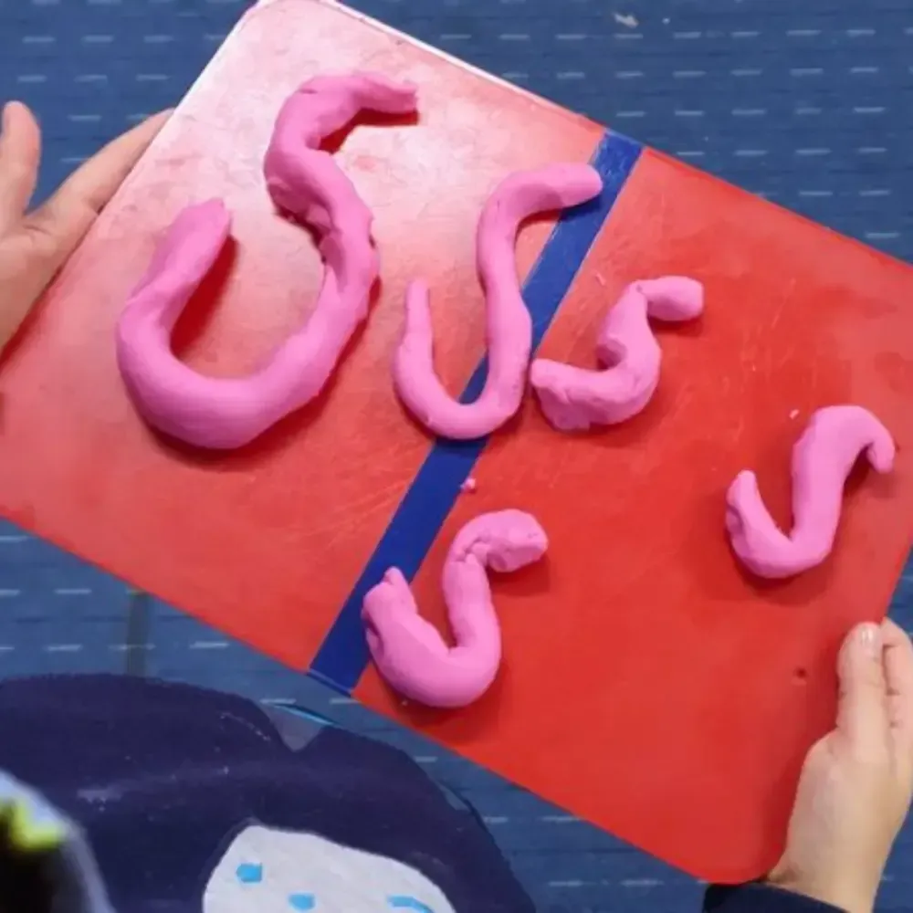 Pink playdough letters spelling 