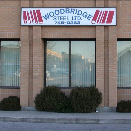 A brick building with a sign that says woodbridge steel ltd