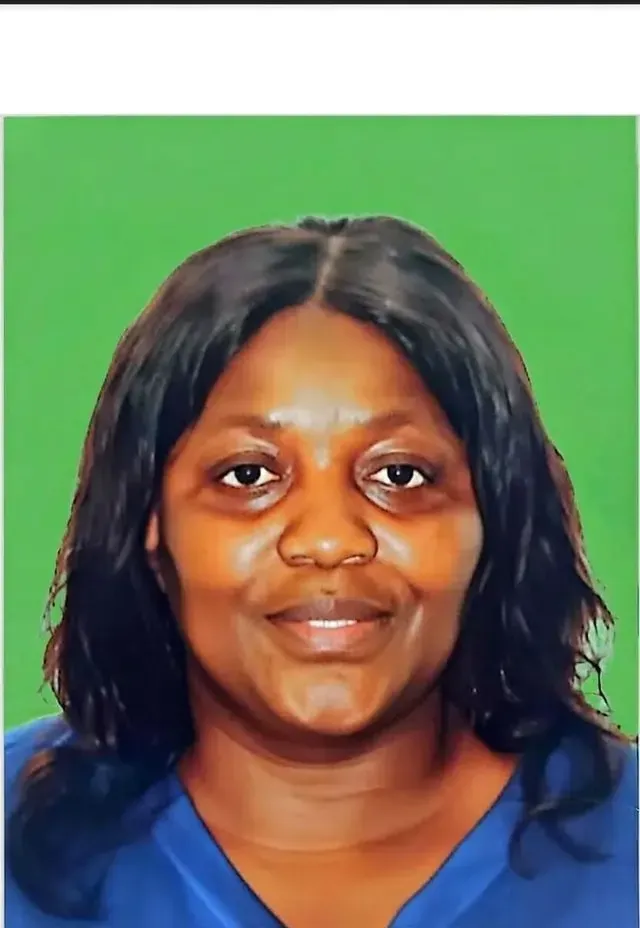 Smiling family assessment centre team member with long dark hair and blue top