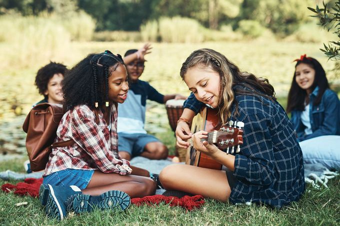 A group of young people are having a picnic in the park.