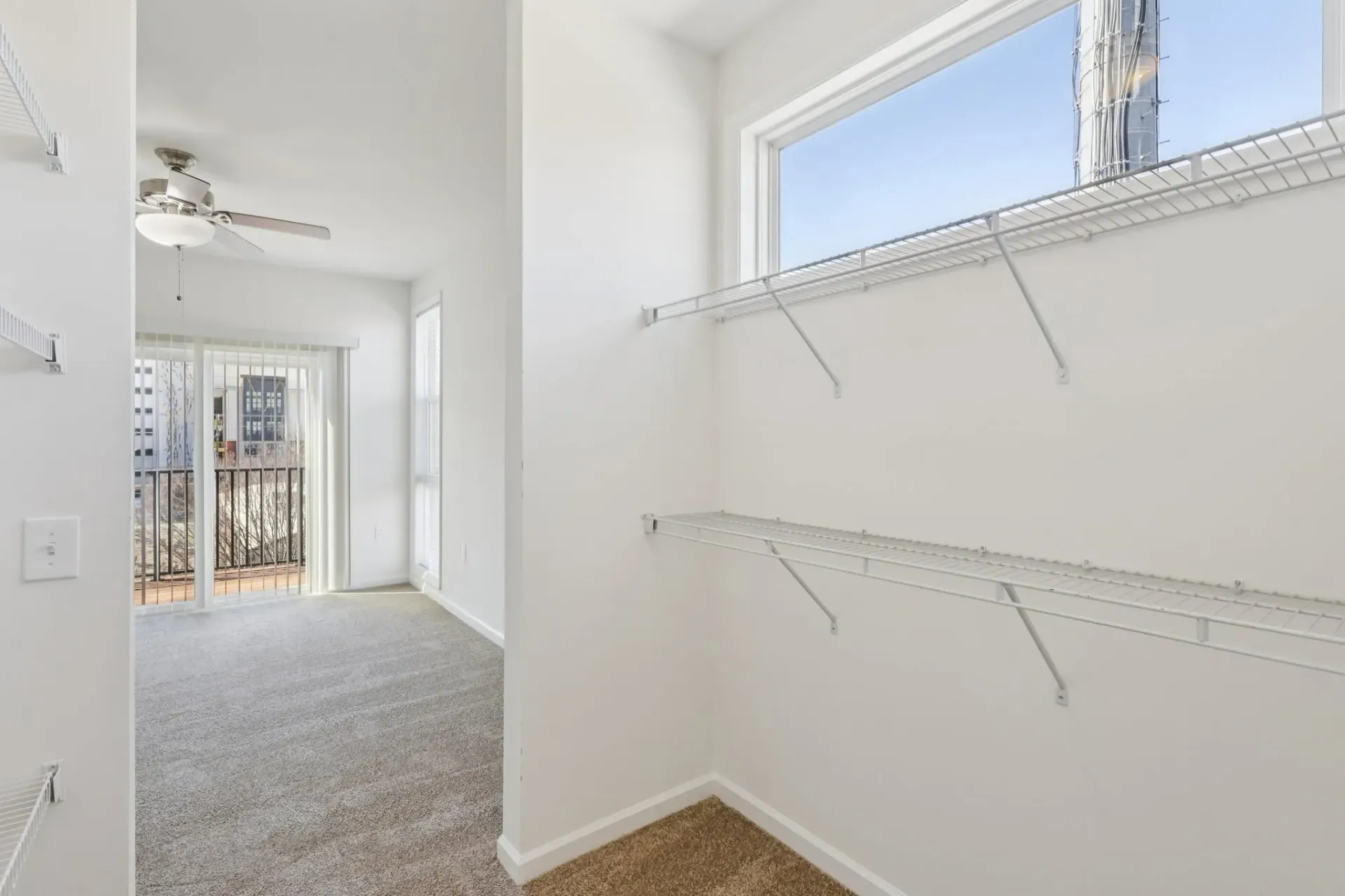 Interior of an apartment with a walk-in closet and a bedroom visible.