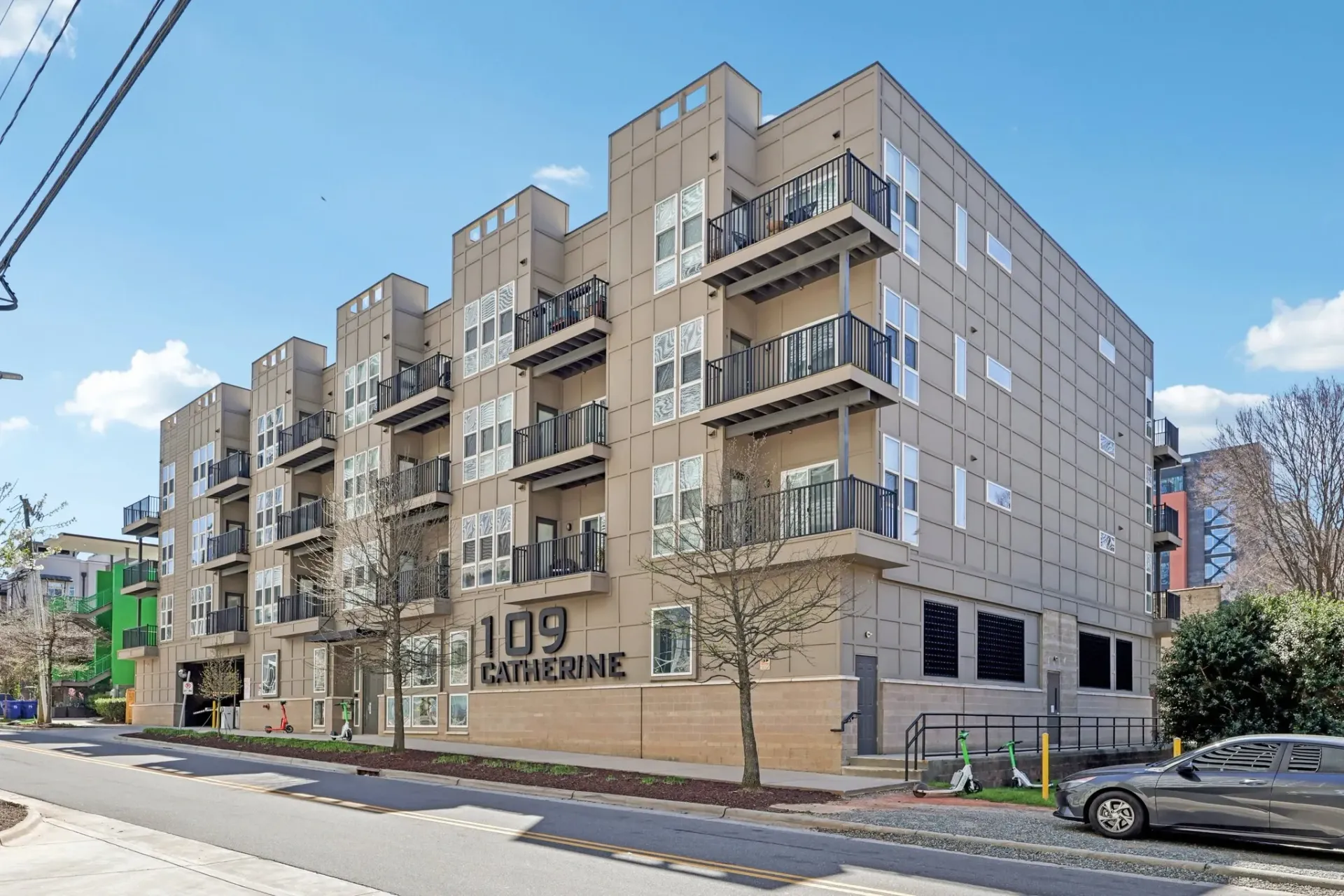 Exterior of the 109 Catherine apartment building with balconies and signage.
