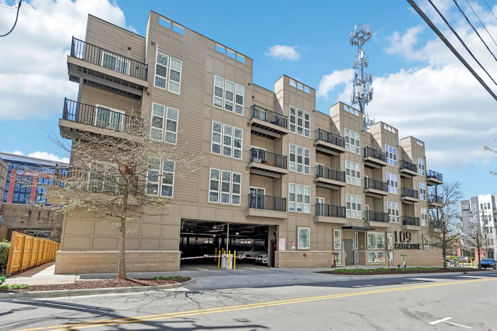 Exterior of the 109 Catherine apartment building with parking garage entrance and balconies.