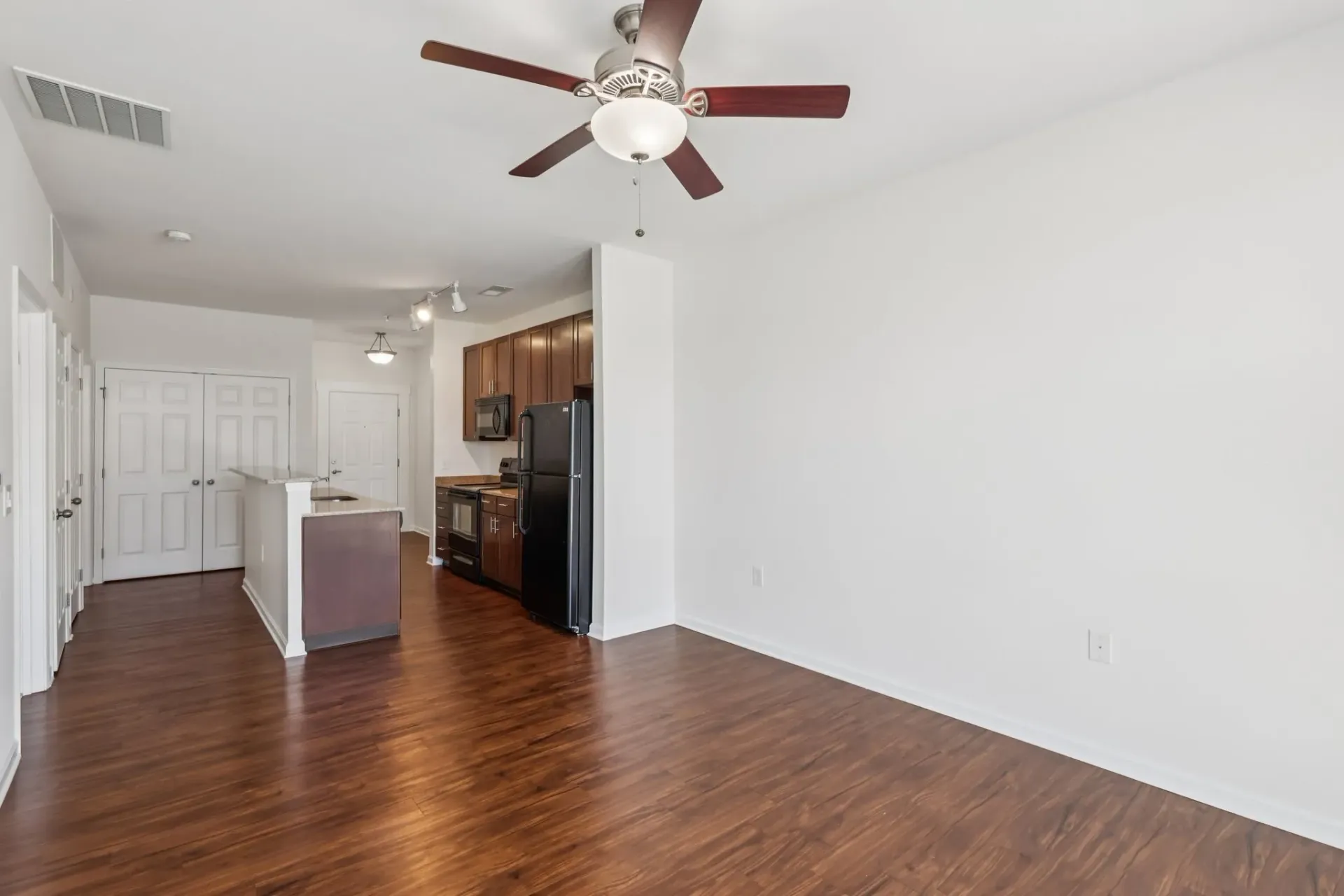 Open concept living area with a kitchen island and kitchen.