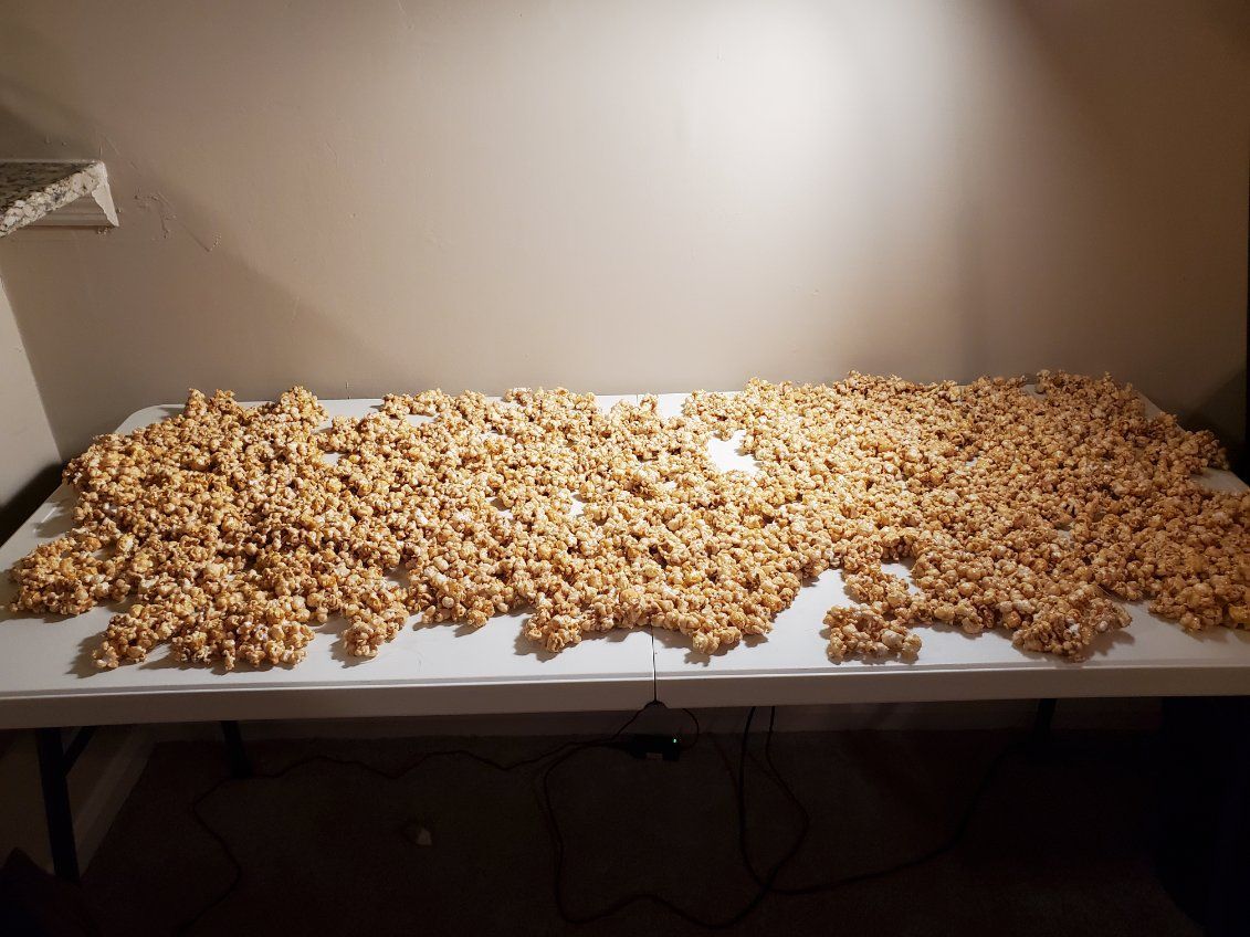 A table covered in a large pile of caramel popcorn
