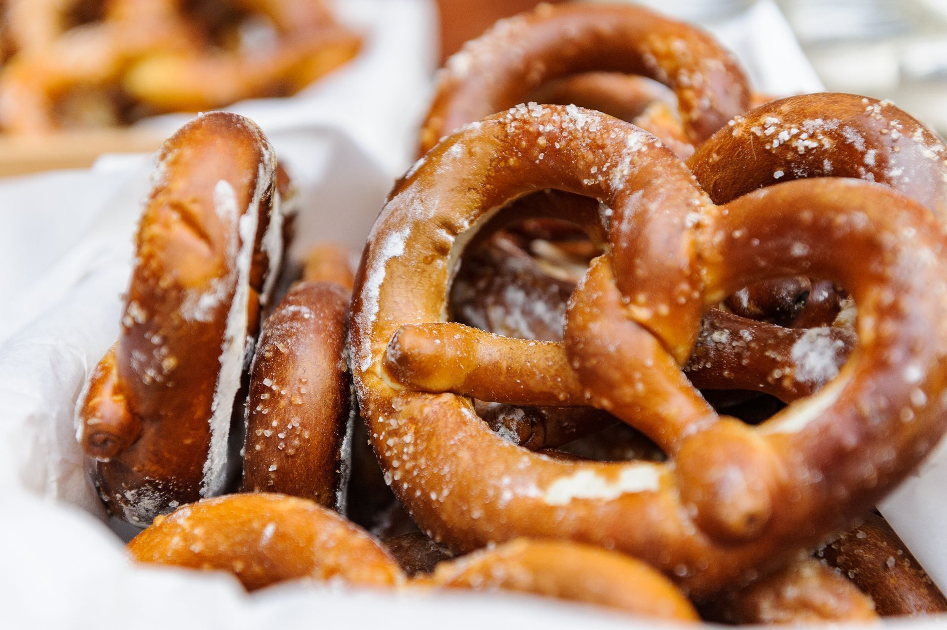Close-up of a basket filled with golden-brown, salted pretzels