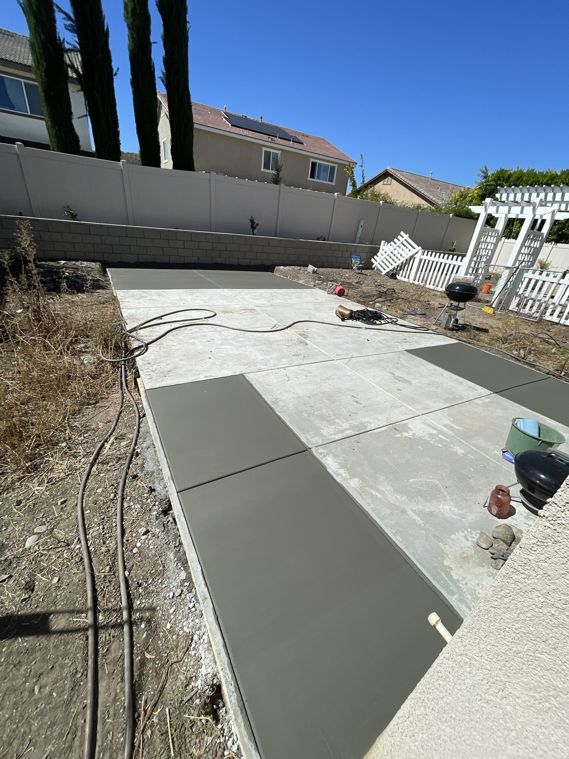 Concrete patio construction with fresh concrete next to older concrete.