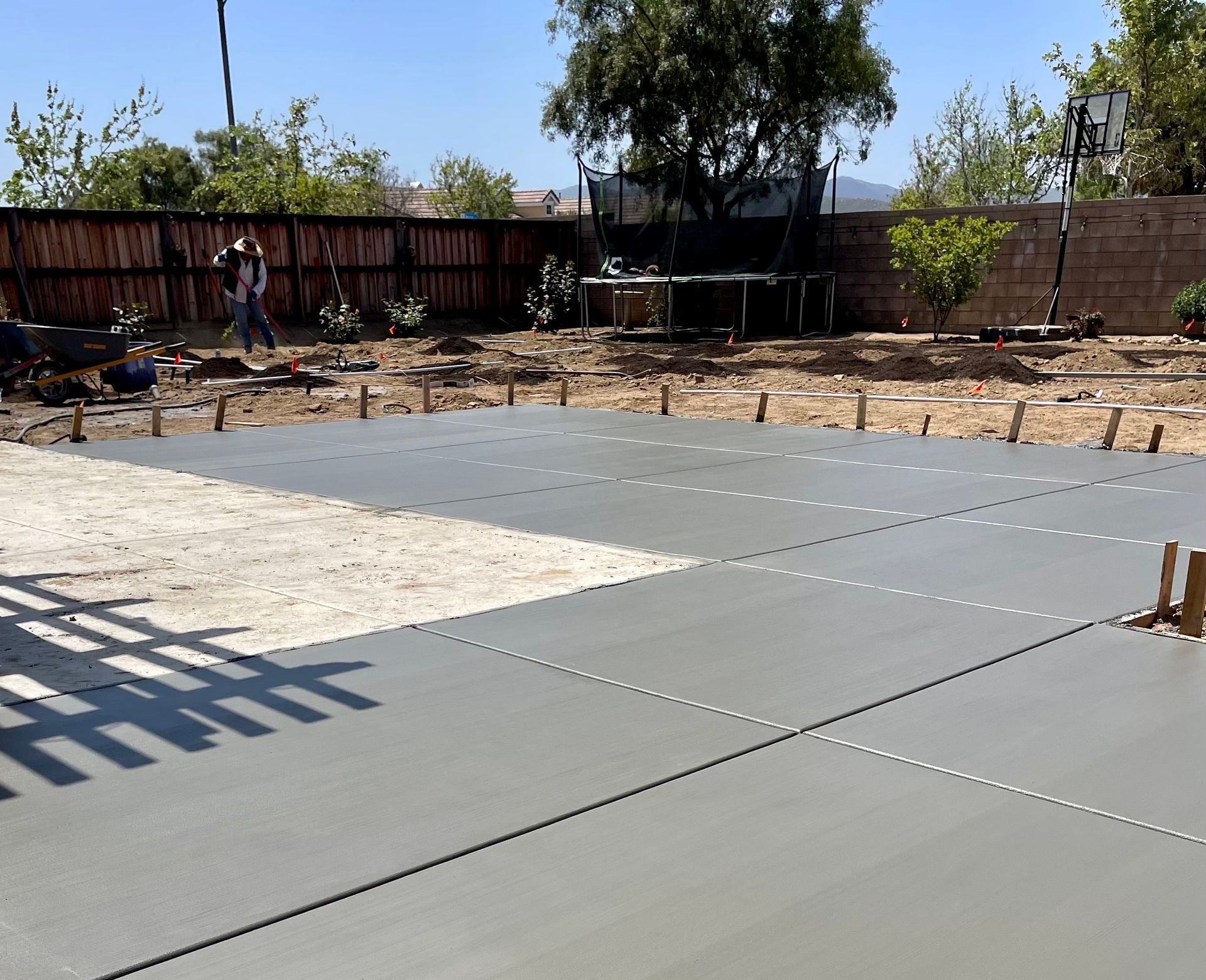 A concrete driveway is being built in a backyard