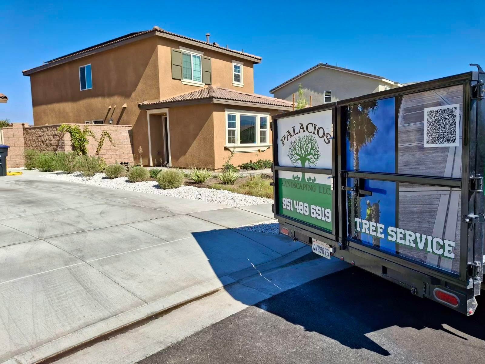 A concrete driveway with a fence in the background