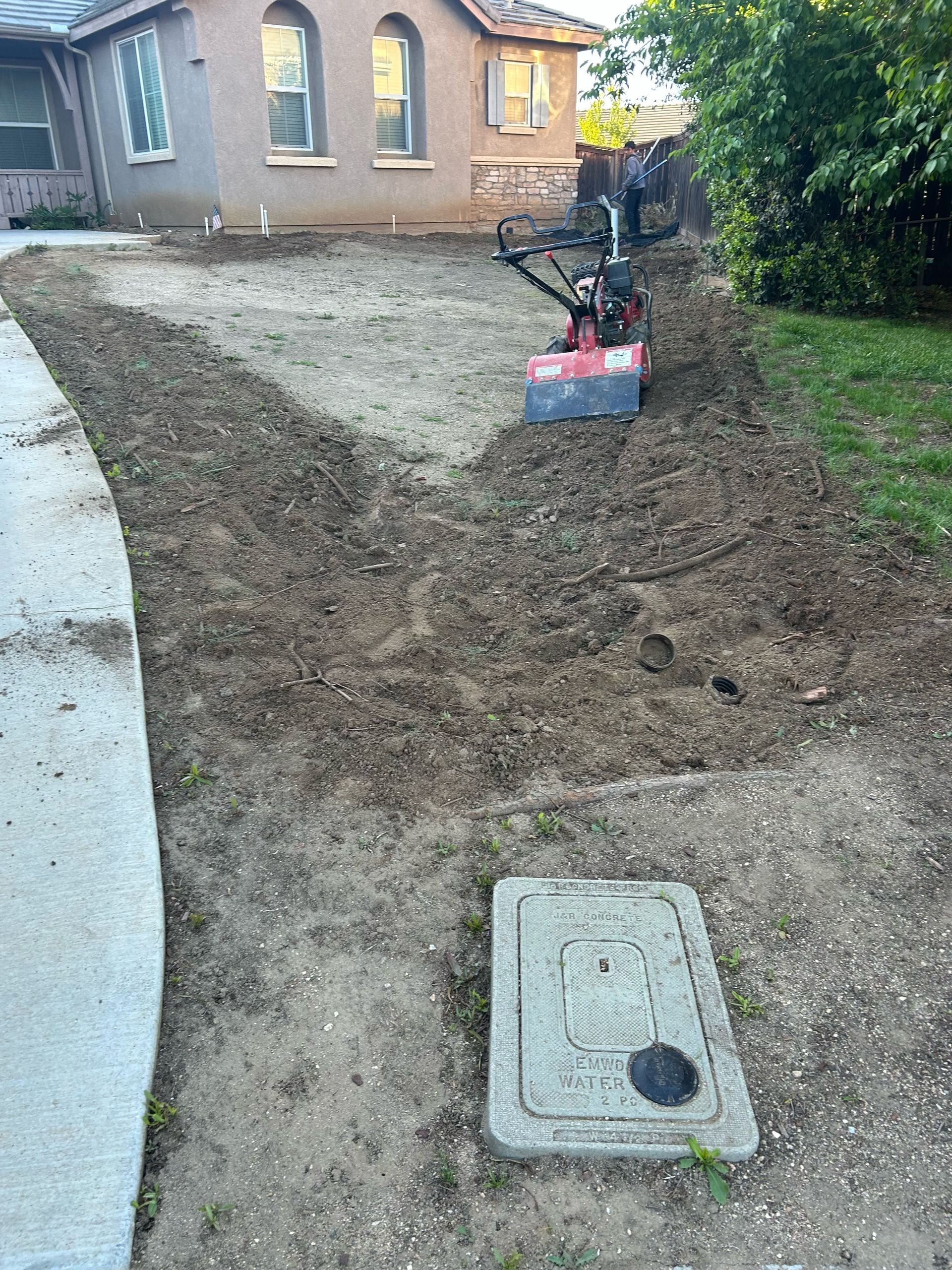 A sprinkler is spraying water on a lush green lawn.