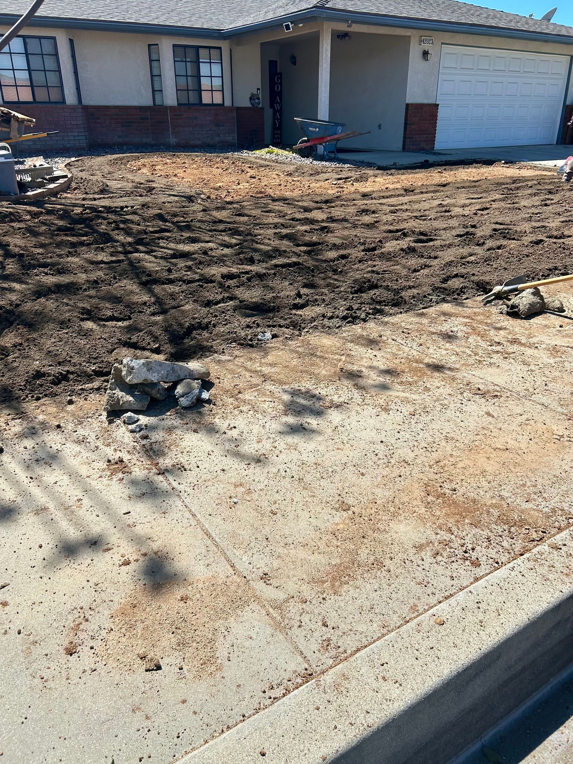 A house with a lot of dirt in front of it.