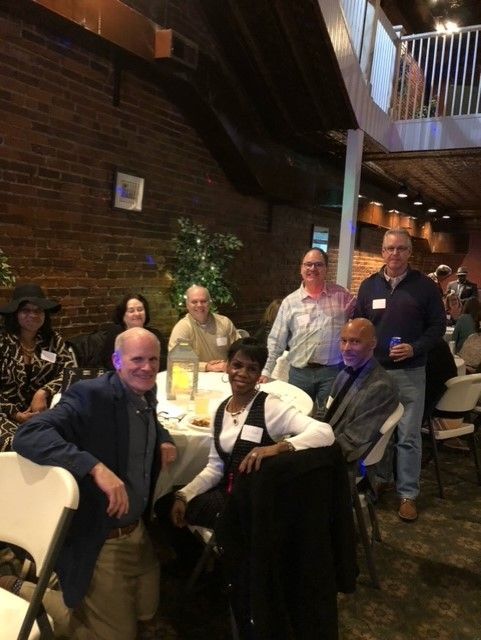 A group of people are posing for a picture in a restaurant.