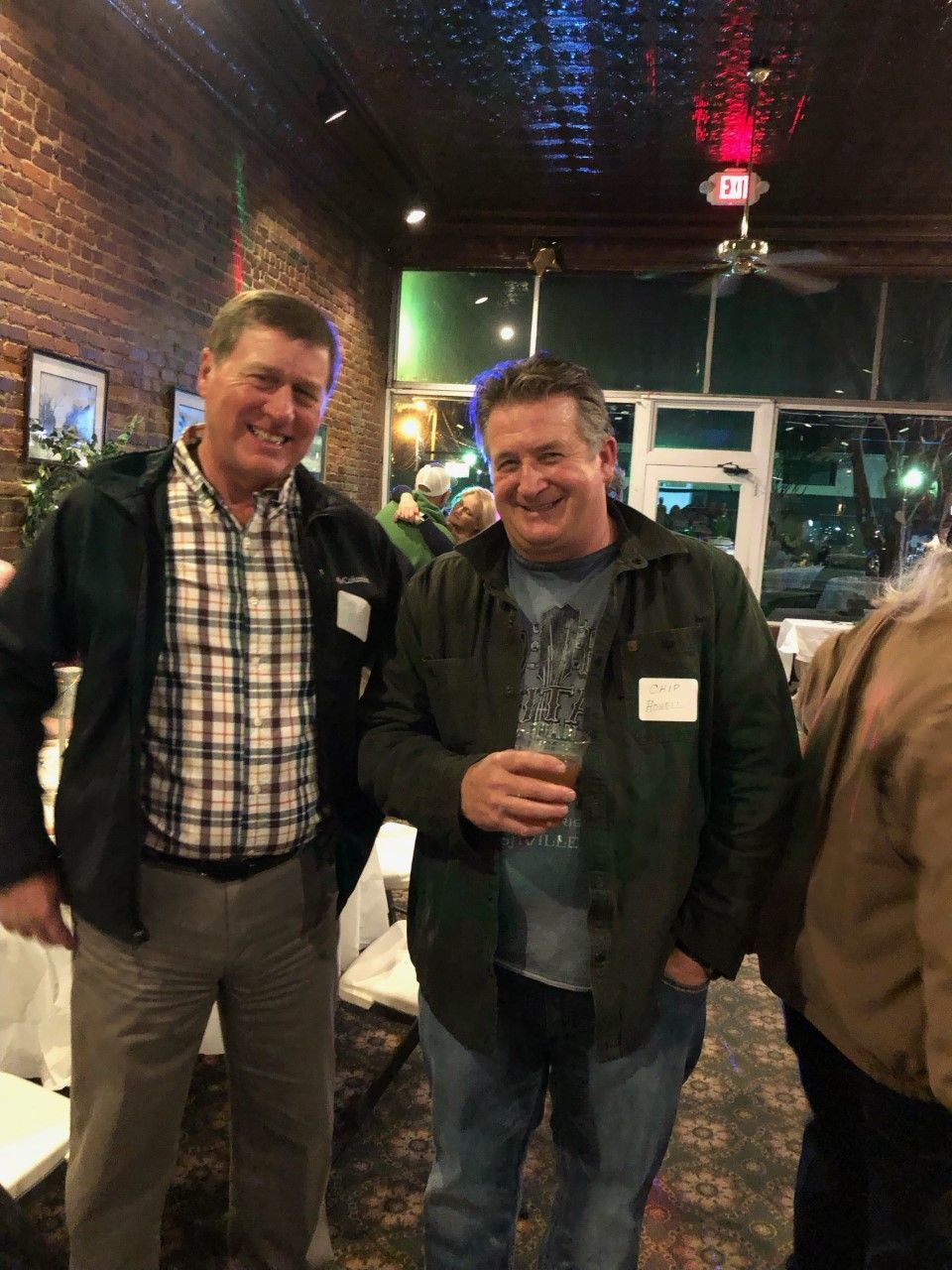 Two men are standing next to each other in a room.