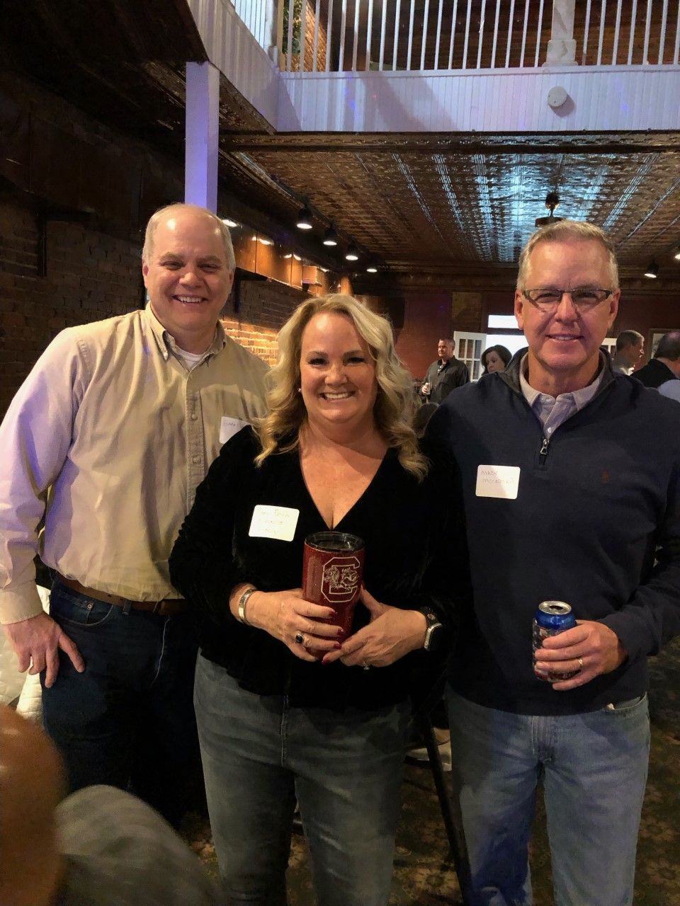 A group of people are posing for a picture in a room.
