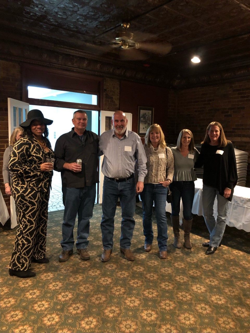 A group of people are posing for a picture in a room.